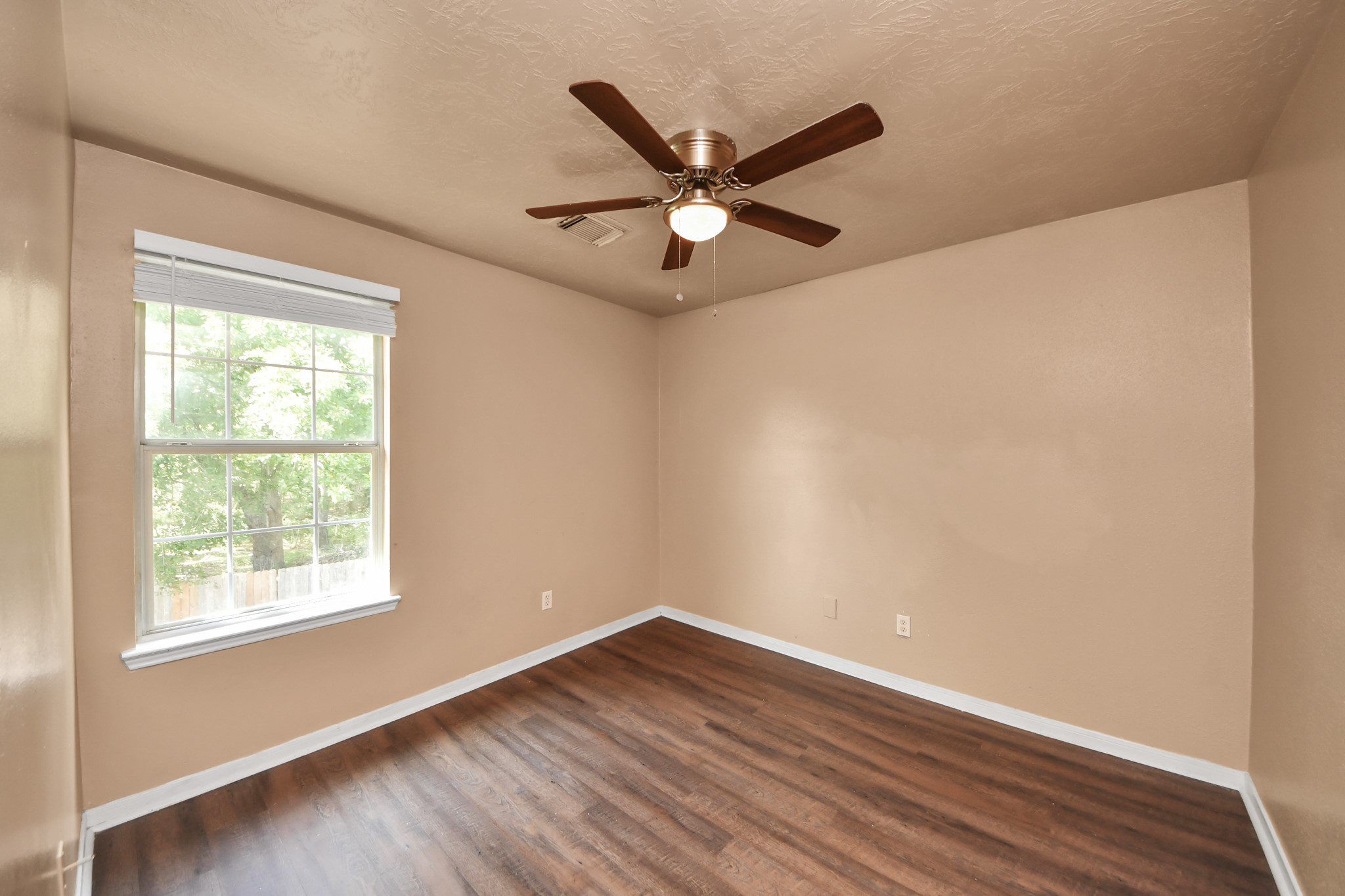 8130 Jutland Road Houston, TX 77033 - Photo 39 of 47 a view of a room with wooden floor and a ceiling fan