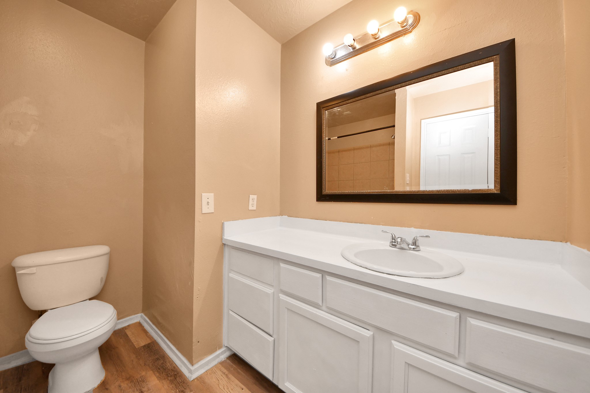 8130 Jutland Road Houston, TX 77033 - Photo 41 of 47 a bathroom with a toilet sink and mirror