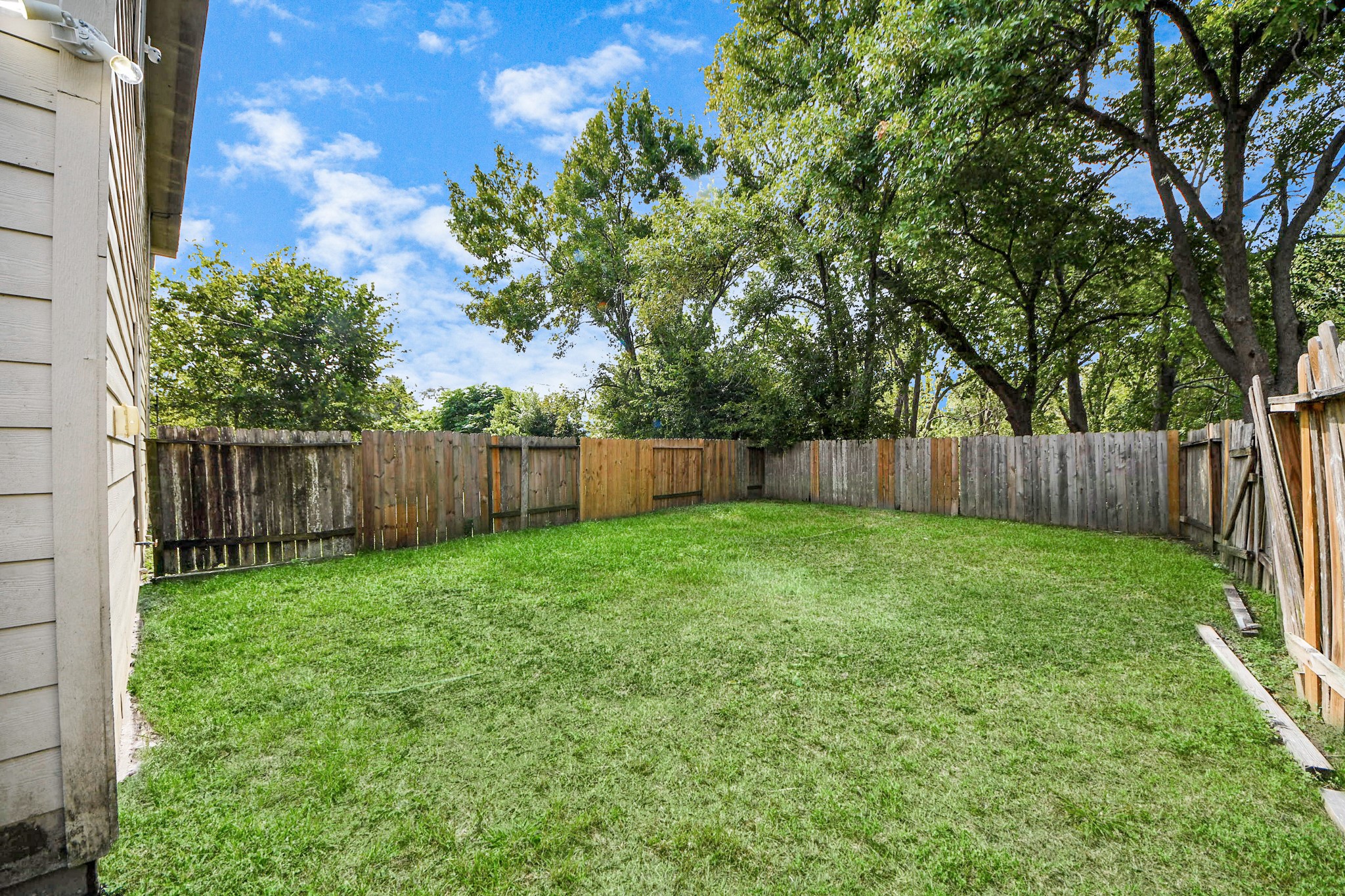 8130 Jutland Road Houston, TX 77033 - Photo 45 of 47 a view of a backyard with a trees and wooden fence