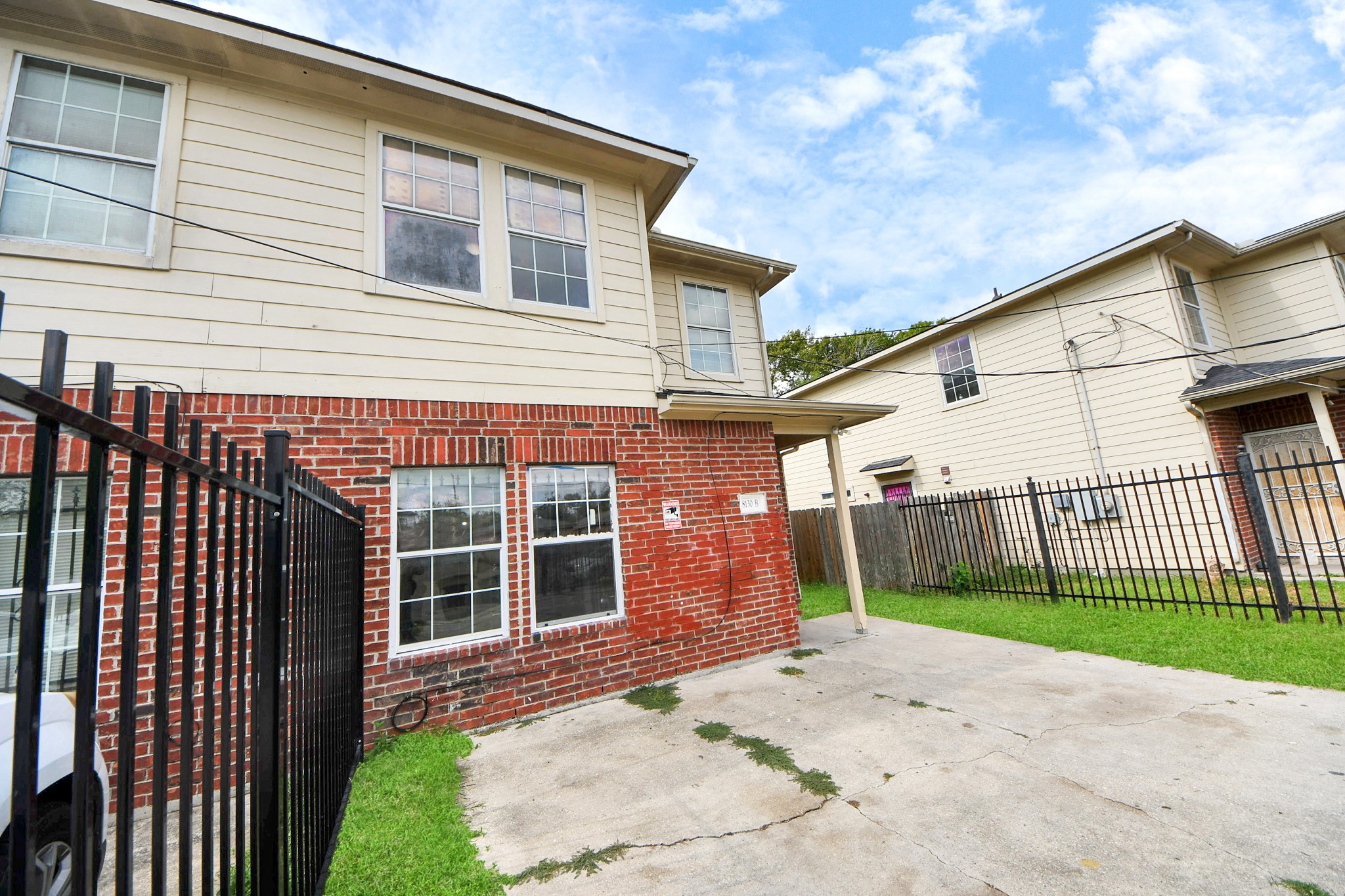 8130 Jutland Road Houston, TX 77033 - Photo 9 of 47 a front view of a house with a garden and yard