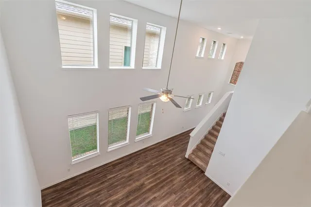 a view of kitchen with wooden floor electronic appliances and stairs
