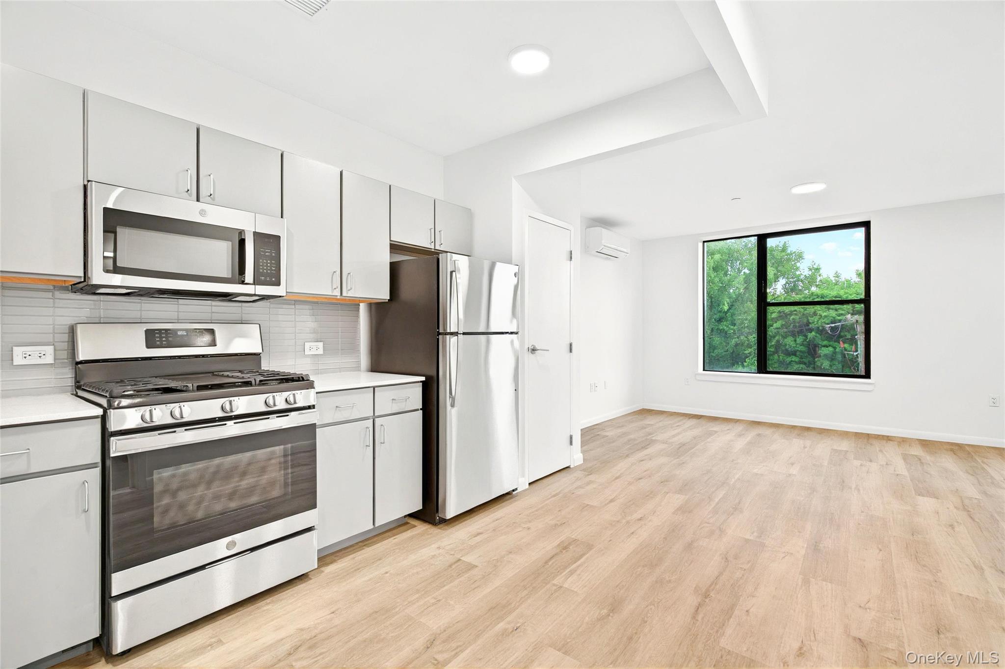 1715 A Lacombe Avenue, Unit 4A Bronx, NY 10473 - Photo 17 of 29 a kitchen with a stove a microwave and refrigerator