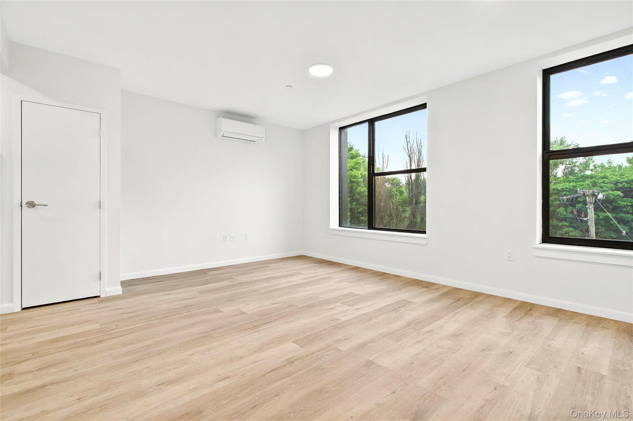 1715 A Lacombe Avenue, Unit 4A Bronx, NY 10473 - Photo 8 of 29 a view of an empty room with wooden floor and a window
