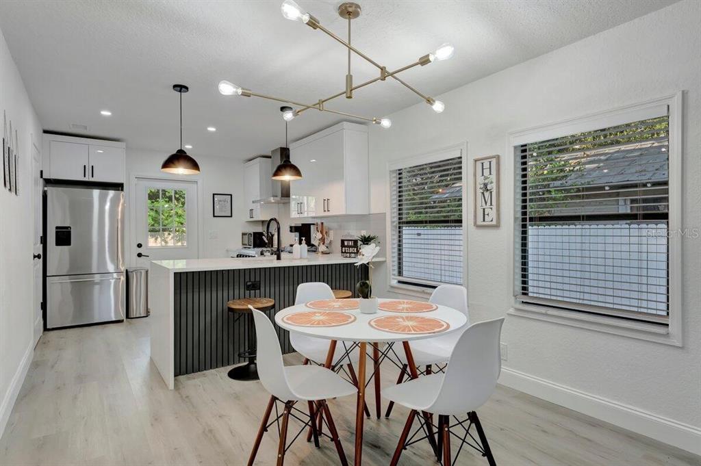 2925 24th Street North St. Petersburg, FL 33713 - Photo 19 of 33 a kitchen with stainless steel appliances kitchen island granite countertop a kitchen island hardwood floor and a sink