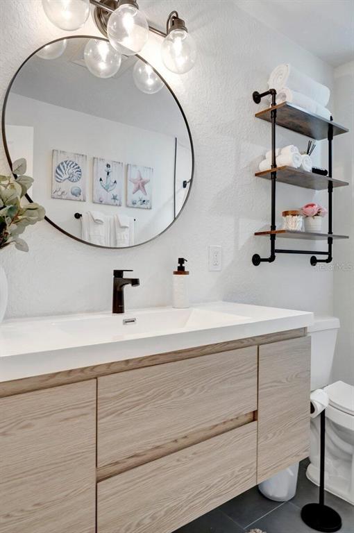 2925 24th Street North St. Petersburg, FL 33713 - Photo 4 of 33 a bathroom with a sink a mirror and vanity