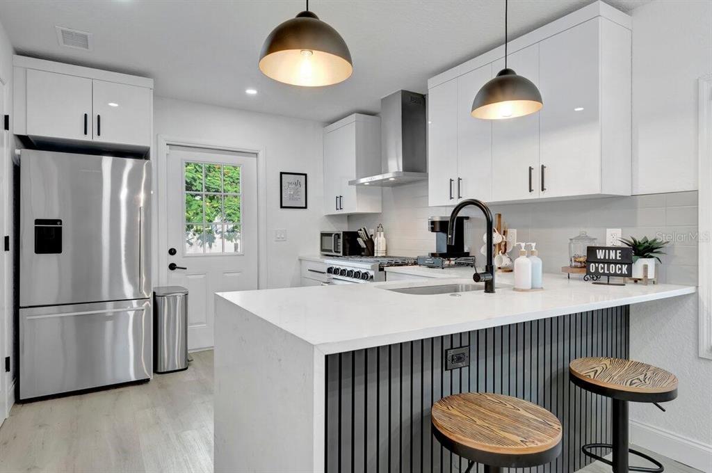 2925 24th Street North St. Petersburg, FL 33713 - Photo 5 of 33 a kitchen with stainless steel appliances granite countertop a sink a refrigerator and a stove