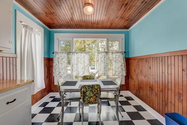 a dining room with furniture a rug and wooden floor
