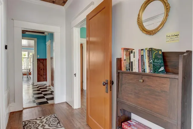 a view of a hallway with entryway wooden floor and front door