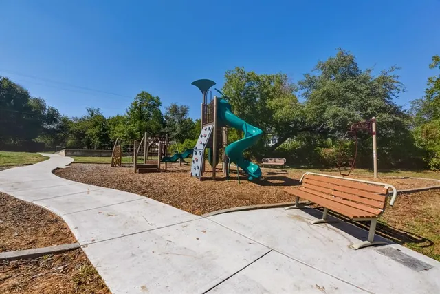 a view of house with backyard and trees