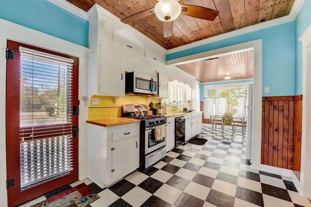 a kitchen with stainless steel appliances a stove a sink and a refrigerator