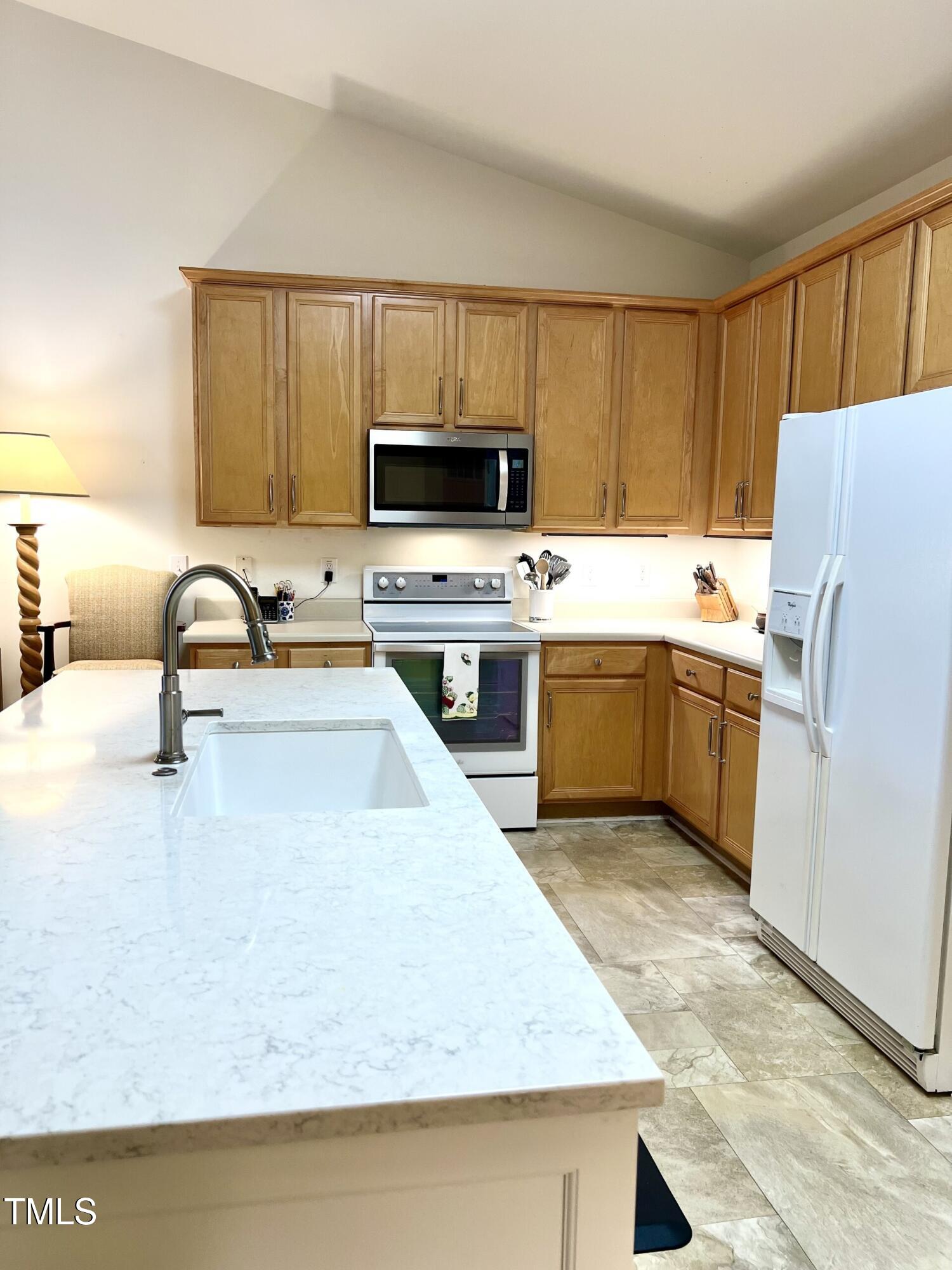 10432 Dapping Drive Raleigh, NC 27614 - Photo 4 of 11 a kitchen with a sink a stove and refrigerator