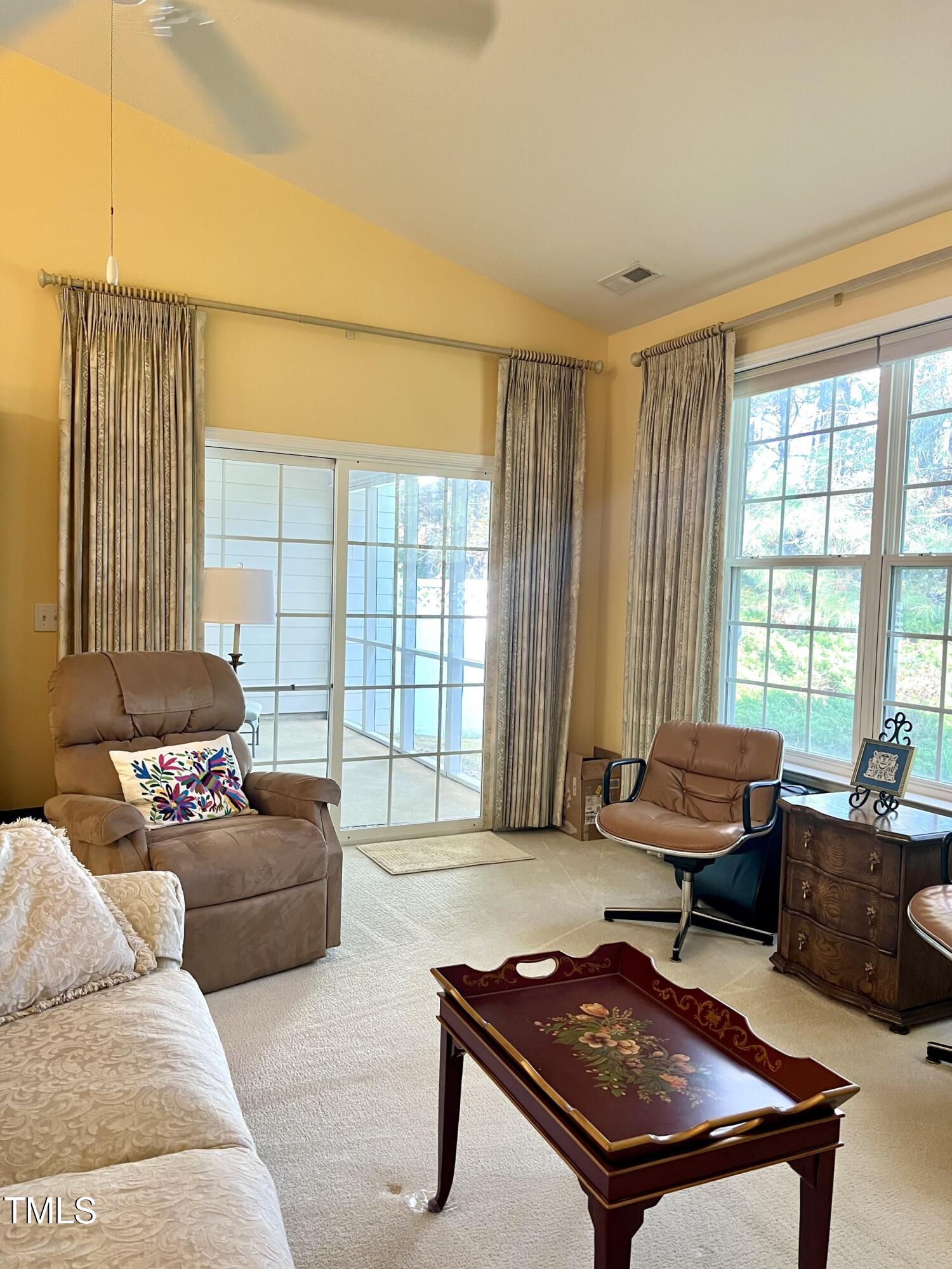 10432 Dapping Drive Raleigh, NC 27614 - Photo 7 of 11 a living room with furniture and a floor to ceiling window