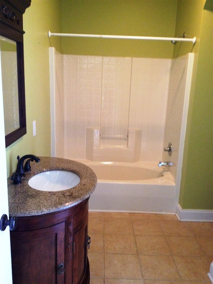 2938 Middlebrook Road Staunton, VA 24401 - Photo 15 of 38 a bathroom with a granite countertop sink a mirror and a bathtub