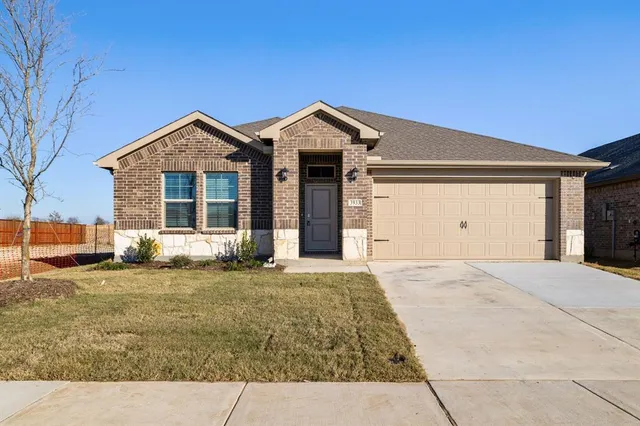 a view of a house with a yard and garage