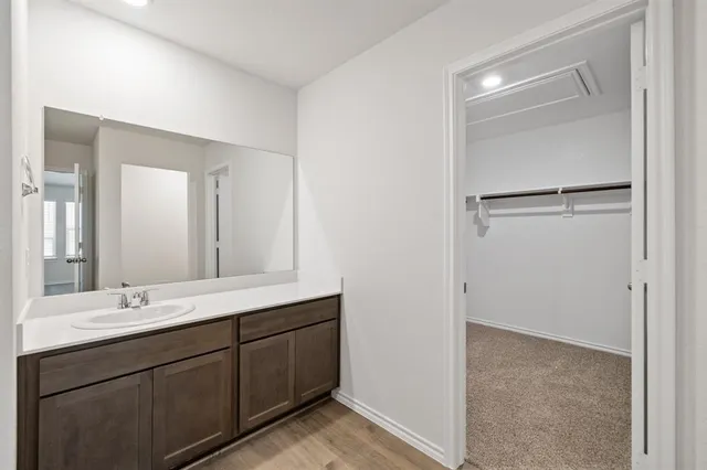 a bathroom with a double vanity sink mirror and shower