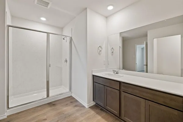 a bathroom with a glass shower door