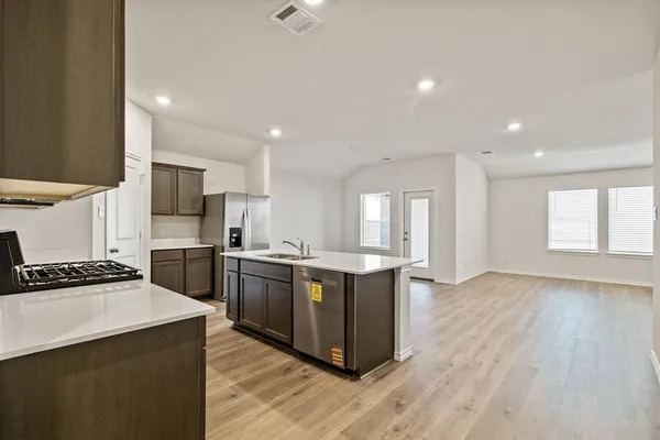 a kitchen that has a sink and a stove