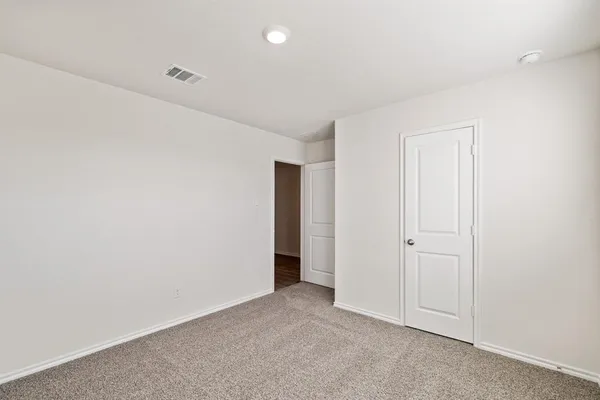 an empty room with closet area