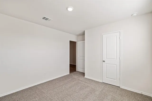 an empty room with closet area