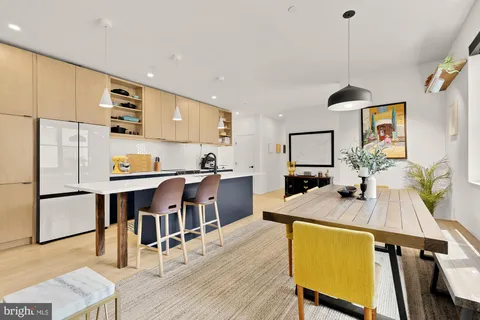 a kitchen with stainless steel appliances granite countertop sink microwave and wooden floor