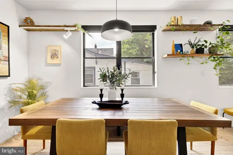 a view of a dining room with a table and chairs