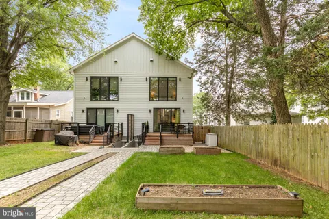 a view of a house with garden and sitting area