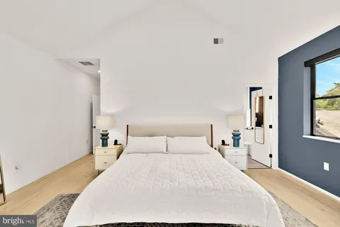 a bedroom with a large bed and a window