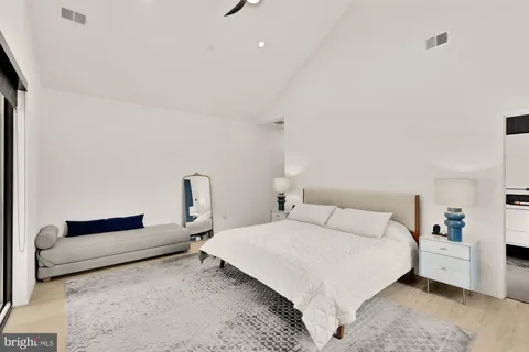 a bedroom with a bed and a lamp on desk