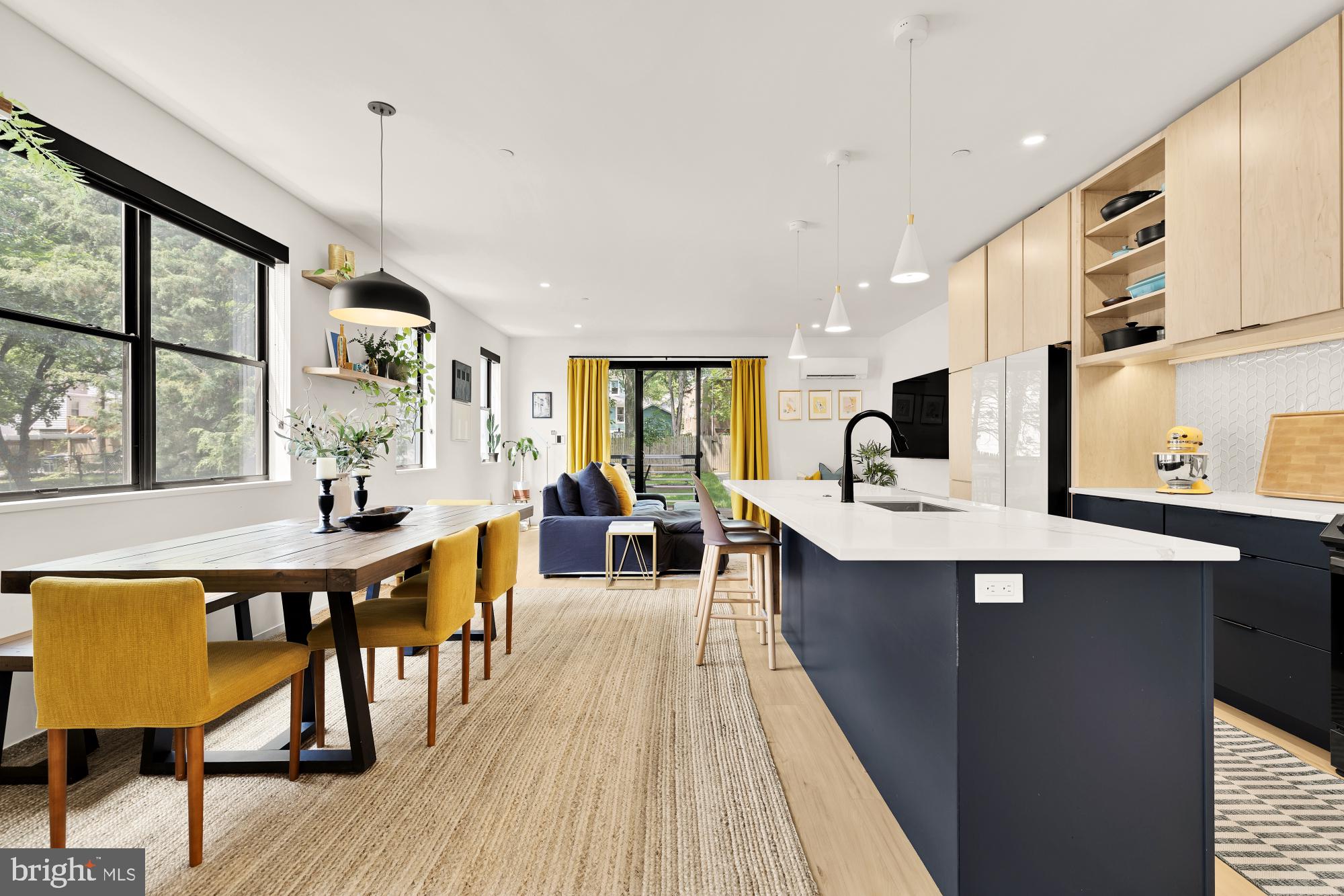 4020 35th Street, Unit B Mount Rainier, MD 20712 - Photo 2 of 42 a large kitchen with kitchen island a large island in the center a sink a window cabinets and stainless steel appliances