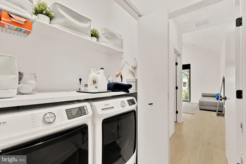 a view of living room with furniture and wooden floor
