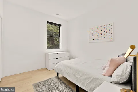 a bedroom with a bed and a window