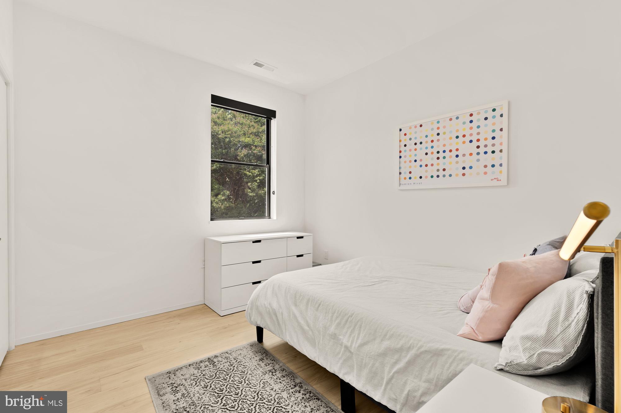 4020 35th Street, Unit B Mount Rainier, MD 20712 - Photo 24 of 42 a bedroom with a bed and a window