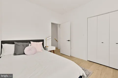 a bedroom with a bed and a night stand