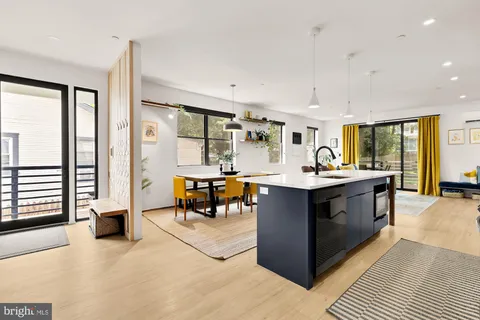 a kitchen with stainless steel appliances kitchen island granite countertop a stove and a sink