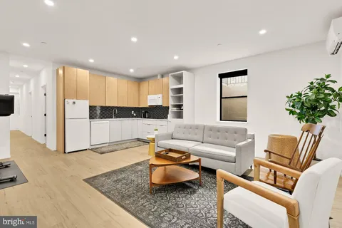 a living room with furniture and a large mirror