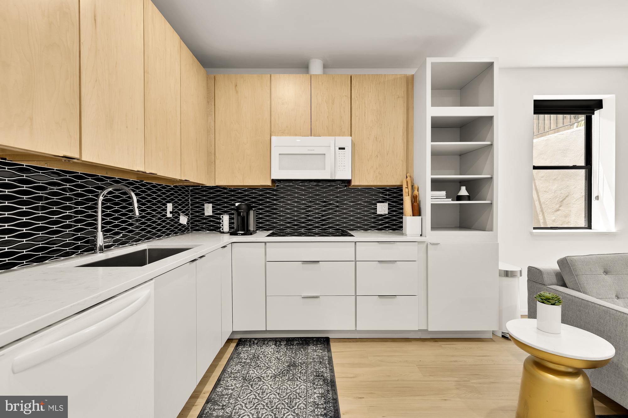 4020 35th Street, Unit B Mount Rainier, MD 20712 - Photo 33 of 42 a kitchen with a sink and cabinets