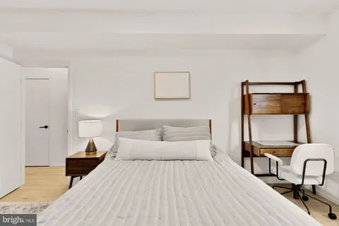 a bedroom with a bed and a chair