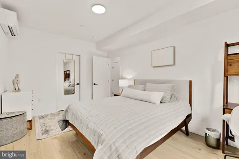 a bedroom with a bed and a couch