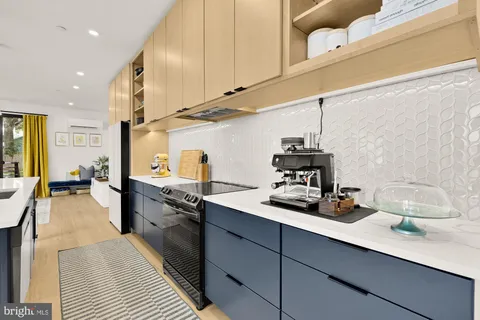a kitchen with counter top space cabinets and appliances