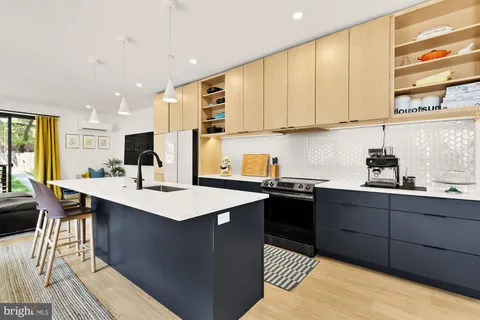 a kitchen with stainless steel appliances granite countertop a sink counter space and a window