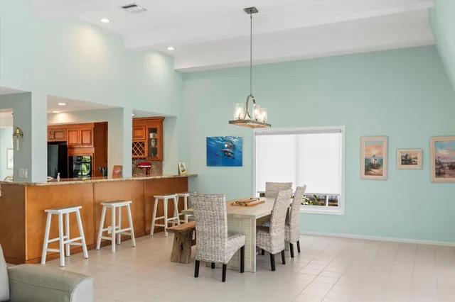 a living room with furniture and a dining table with kitchen view