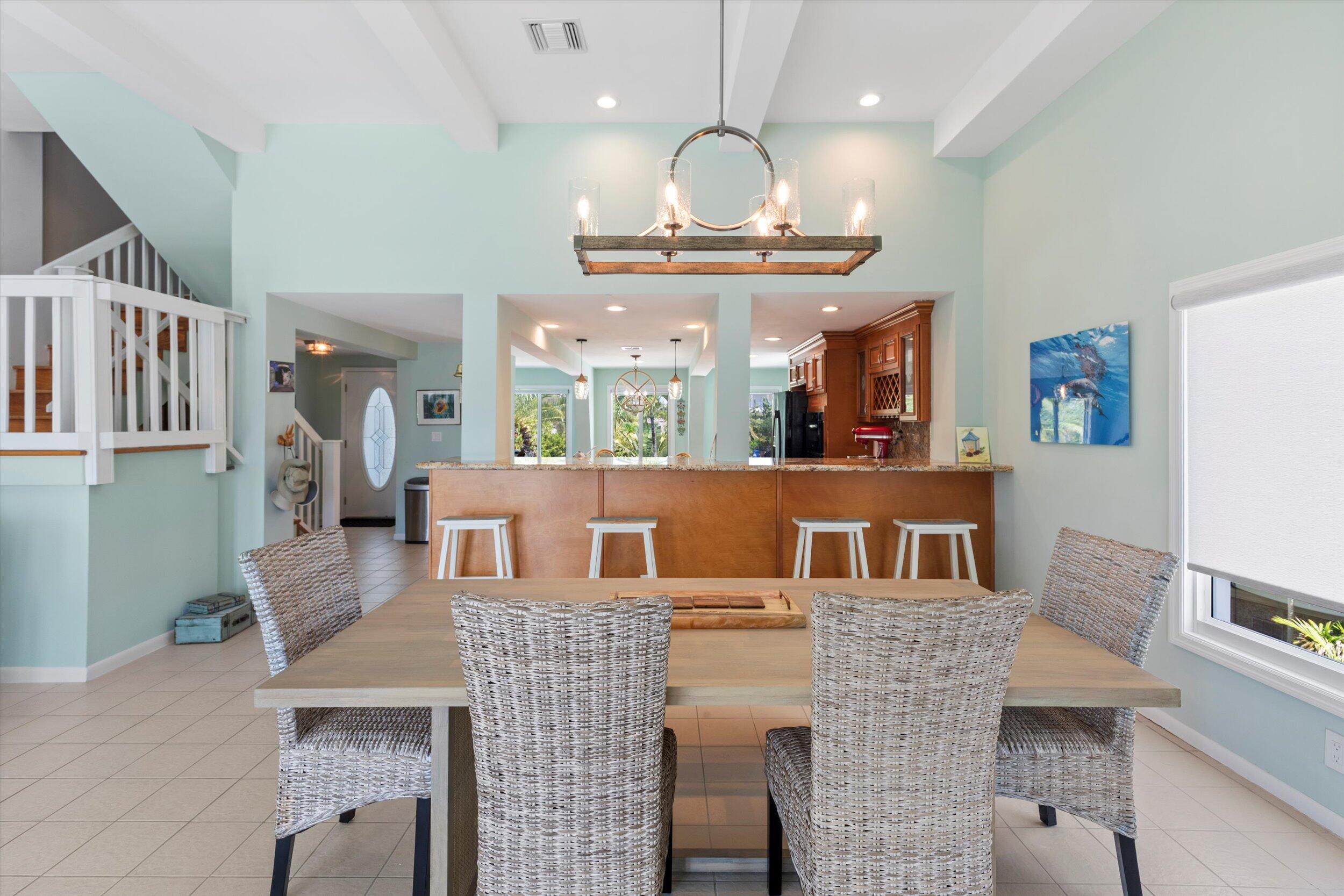 680 Cruikshank Lane Summerland Key, FL 33042 - Photo 20 of 101 a kitchen with stainless steel appliances kitchen island granite countertop a stove a kitchen island a dining table and chairs
