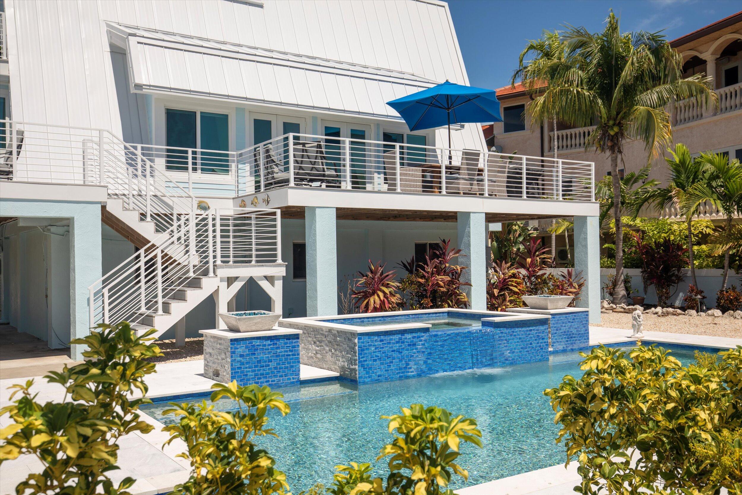 680 Cruikshank Lane Summerland Key, FL 33042 - Photo 5 of 101 a view of a house with backyard porch and patio