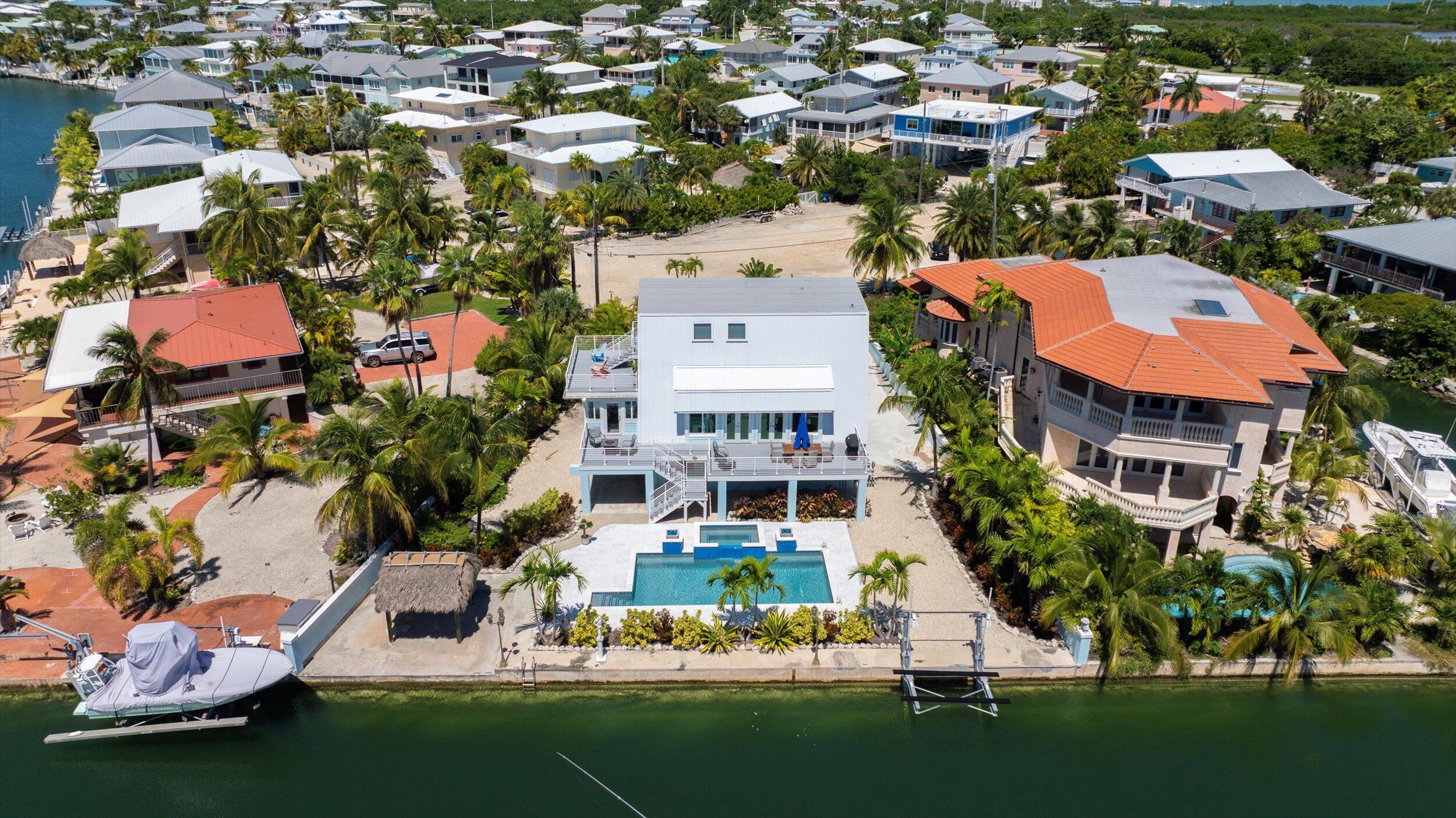 680 Cruikshank Lane Summerland Key, FL 33042 - Photo 84 of 101 an aerial view of a house with a garden and lake view