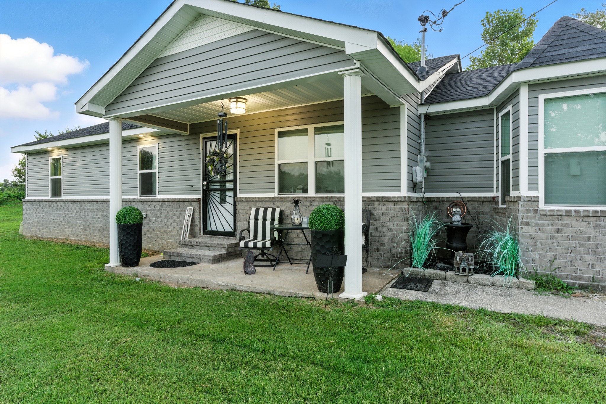 a view of a chair and table in backyard of the house