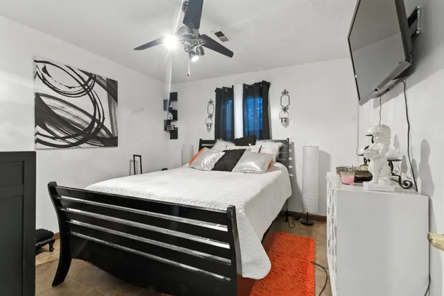 a bed room with a bed and a chandelier