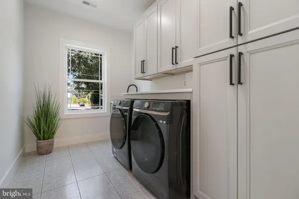 a utility room with wooden floor washer and dryer