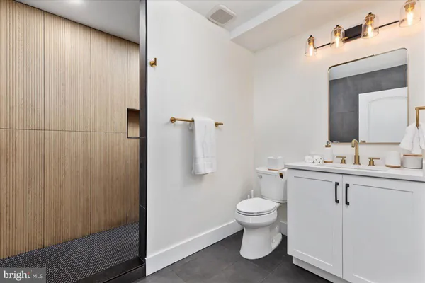 a bathroom with a toilet a sink and a mirror