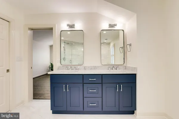 a bathroom with a double vanity sink and a mirror