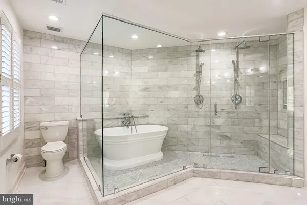 a bathroom with a shower a toilet and a shower